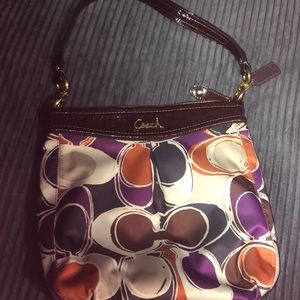 Coach multi color bag with extra strap.